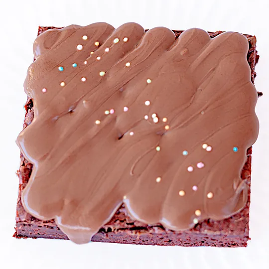 Red Velvet Brownie -pala ylhäältä, päällä suklaakuorrute ja nonparelleja